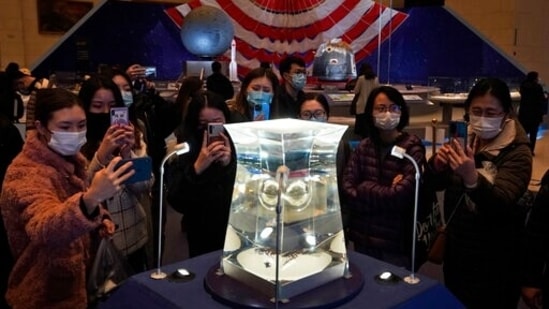 Visitors at the National Museum look at a display of the lunar rock samples retrieved from the moon by China's Chang'e 5 lunar lander late last year in Beijing. (AP Photo/Ng Han Guan, File) Visitors at the National Museum look at a display of the lunar rock samples retrieved from the moon by China's Chang'e 5 lunar lander late last year in Beijing. (AP Photo/Ng Han Guan, File)