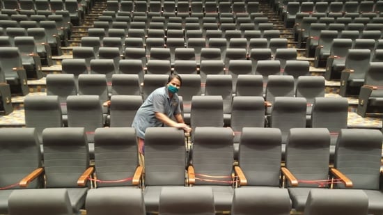 Workers sanitise NMMC Vishnudas Bhave Auditorium in Navi Mumbai ahead of the reopening of theatres from October 22.&nbsp;(Bachchan Kumar / Hindustan Times)