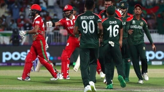 Oman's batsman Jatinder Singh, left, the crease after being dismissed by Bangladesh's Shakib Al Hasan during the Cricket Twenty20 World Cup first round match between Oman and Bangladesh in Muscat, Oman, Tuesday, Oct. 19, 2021.(AP)