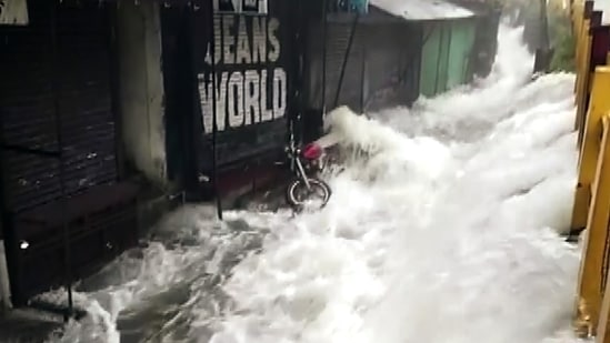 Water gushes from the Nainital Lake as it overflows and floods the streets amid incessant rainfall in Uttarakhand.&nbsp;(ANI Photo)