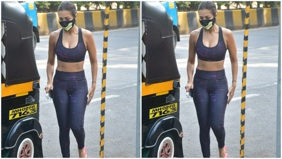 For footwear, she chose comfy pink flip flops to go with her attire. She held her phone in one hand as she made her way past the cameras.(HT Photos/Varinder Chawla)