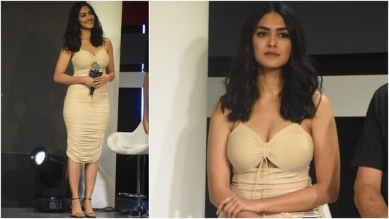 Mrunal chose a chic nude-coloured ensemble for the special occasion. Her calf-length dress came with a plunging sweetheart neckline, spaghetti straps, a cut-out detail on the front, and a ribbon tie on the torso.(HT Photo/Varinder Chawla)
