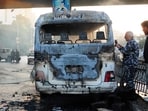 A handout picture released by the official Syrian Arab News Agency (SANA) shows a charred Syrian army bus that was targeted with explosive devices in the Syrian capital of Damascus on October 20, 2021. (AFP)