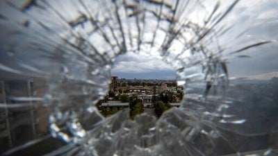 In this Thursday, May 6, 2021 file photo, the city of Mekele is seen through a bullet hole in a stairway window of the Ayder Referral Hospital, in the Tigray region of northern Ethiopia.&nbsp; (AP)