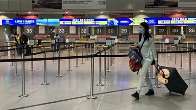 A passenger wearing a face-covering walks past the Ryanair check-in desks at Manchester Airport in Manchester, Britain.&nbsp; (File Photo / REUTERS)