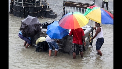 Commuters wade through a waterlogged National Highway in Malda, on Wednesday. (PTI) Commuters wade through a waterlogged National Highway in Malda, on Wednesday. (PTI)