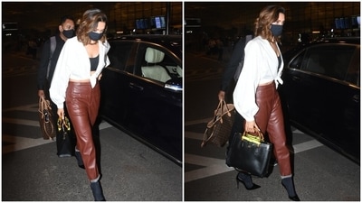 Deepika teamed the top with high-waisted and straight fit dark tan brown faux leather pants. She folded the cuffs to give her look an effortless touch. (HT Photo/Varinder Chawla) Deepika teamed the top with high-waisted and straight fit dark tan brown faux leather pants. She folded the cuffs to give her look an effortless touch. (HT Photo/Varinder Chawla)