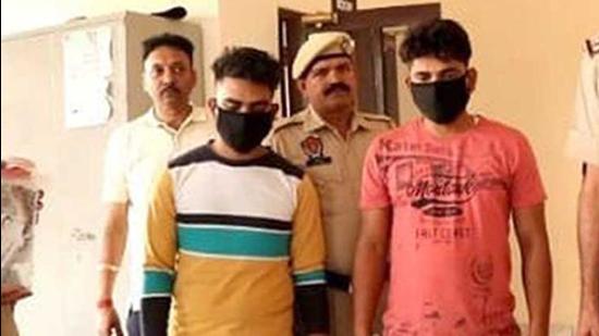 Two of the robbery accused in police custody in Ludhiana on Wednesday. (HT Photo) Two of the robbery accused in police custody in Ludhiana on Wednesday. (HT Photo)
