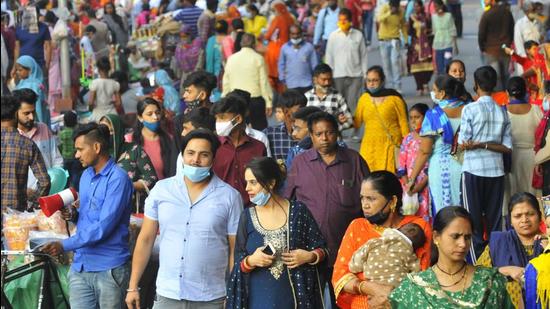 Visitors disregarding the need for masks and social distancing at a fair organised on the occasion of Valmiki Jayanti in Sector 24, Chandigarh, on Wednesday. (Keshav Singh/HT)