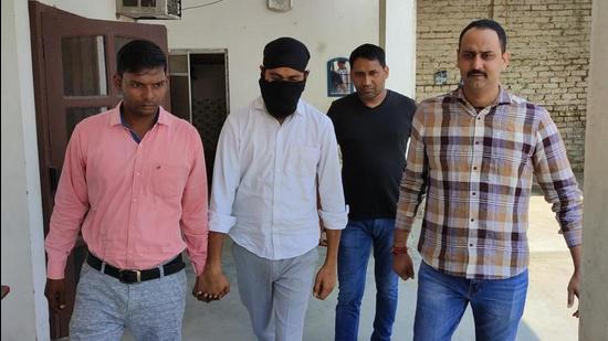 Accused Beant Singh Aujla, alias Preet Aujla, a resident of Tarn Taran in Punjab who runs Maha Music and Films Production House Private Limited in Mohali, in police custody on Wednesday. (HT PHOTO)
