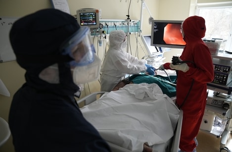 Medics wearing special suits to protect against Covid-19 treat a patient with coronavirus at an ICU at the Moscow City Clinical Hospital 52, in Moscow, Russia (AP Photo)
