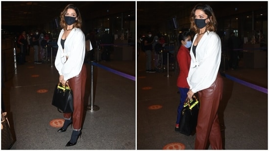 Deepika, Who Is Married To Ranveer Singh, Arrived At The Mumbai Airport Dressed In A Chic Ensemble That Included A White Shirt, Faux Leather Pants, And A Bralette. Serving Boss Lady Vibes, Deepika Looked Ultra-Glam In The Attire.(Ht Photo/Varinder Chawla)