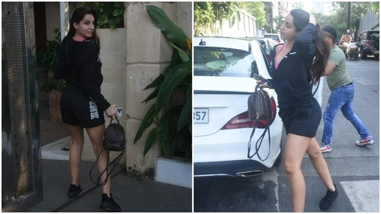 A hot pink sports bra added a dash of colour to Nora's look. The star accessorised the outfit with a Louis Vuitton backpack, chunky black sneakers, and pretty ear studs. She left her locks open in a side parting and rounded it off with minimal make-up.(HT Photo/Varinder Chawla)