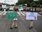 Volunteers hold placards at a traffic point as part of the Delhi government's ‘Red Light On, Gaadi Off’ campaign to reduce pollution levels in the national capital at ITO in New Delhi on Monday. (ANI) Volunteers hold placards at a traffic point as part of the Delhi government's ‘Red Light On, Gaadi Off’ campaign to reduce pollution levels in the national capital at ITO in New Delhi on Monday. (ANI)