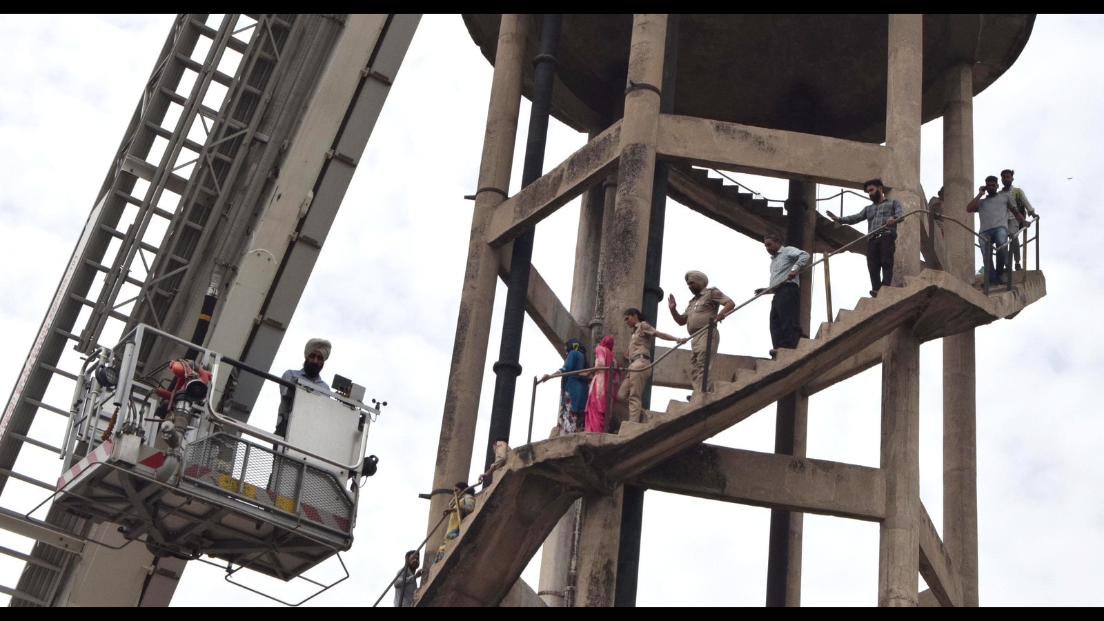Kharar Two protesting unemployed teachers climb atop water tank