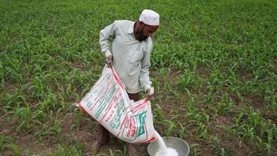 A farmer prepares to spread fertiliser in his maize field on the outskirts of Ahmedabad, India. The US report said the intelligence community assessed that 11 countries are likely to face “warming temperatures, more extreme weather, and disruption to ocean patterns that will threaten their energy, food, water, and health security”. (REUTERS) A farmer prepares to spread fertiliser in his maize field on the outskirts of Ahmedabad, India. The US report said the intelligence community assessed that 11 countries are likely to face “warming temperatures, more extreme weather, and disruption to ocean patterns that will threaten their energy, food, water, and health security”. (REUTERS)