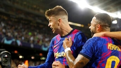 Barcelona's Gerard Pique, right, celebrates with his teammate Memphis Depay after scoring his side's first goal during a Champions League group E soccer match between F.C. Barcelona and Dinamo Kyiv at Camp Nou stadium in Barcelona, Spain, Wednesday, Oct. 20, 2021. (AP Photo/Joan Monfort) (AP) Barcelona's Gerard Pique, right, celebrates with his teammate Memphis Depay after scoring his side's first goal during a Champions League group E soccer match between F.C. Barcelona and Dinamo Kyiv at Camp Nou stadium in Barcelona, Spain, Wednesday, Oct. 20, 2021. (AP Photo/Joan Monfort) (AP)