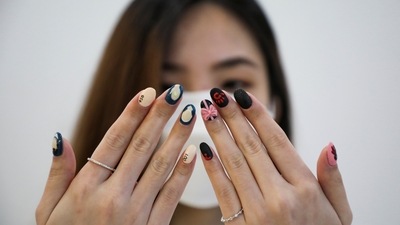 A customer flaunts her Squid Game's inspired manicure at a nail salon in Kuala Lumpur, Malaysia. (REUTERS)