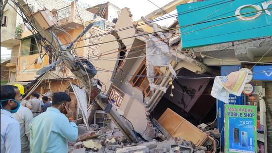 The two-storey building collapsed in Sangam Vihar. It was being lifted using jacks, officials said. Delhi Fire Services chief Atul Garg said no casualty has been reported in the incident. (HT Photo)
