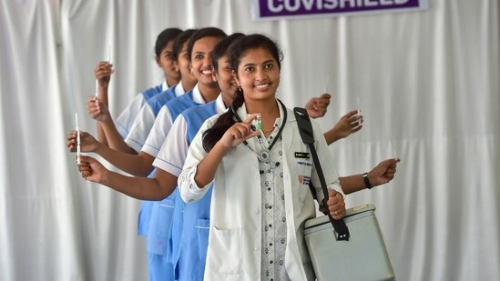 Nursing staff of the M S Ramaiah hospital pose holding vaccines and syringes to celebrate the 1 billion Covid-19 vaccine dose milestone, in Bengaluru, Thursday. (PTI)