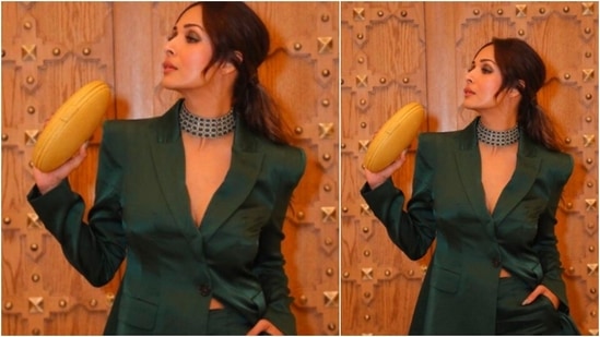 Malaika Arora flaunted her yellow hand purse as she posed in a green pantsuit.(Instagram/@malaikaaroraofficial)