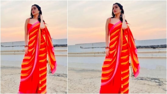 Shraddha Kapoor opted for this bright yellow and orange saree for a photoshoot on the terrace.(Instagram/@shraddhakapoor)