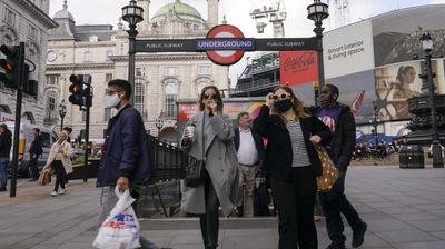 People wear face masks as they exit Piccadilly Circus underground station, in London, Tuesday, Oct. 19, 2021 (AP Photo) People wear face masks as they exit Piccadilly Circus underground station, in London, Tuesday, Oct. 19, 2021 (AP Photo)