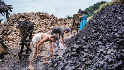 File photo: Daily wage laborers shovel coal into baskets at a limestone quarry in Lower Cherrapunji in Meghalaya. (Bloomberg) File photo: Daily wage laborers shovel coal into baskets at a limestone quarry in Lower Cherrapunji in Meghalaya. (Bloomberg)