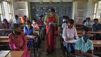 A teacher conducts a class at a school in Bangalore on September 6. (AFP)