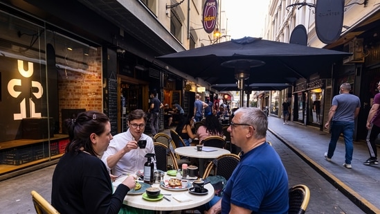 People dine outdoors in Degraves Street in Melbourne, Friday, Oct. 22, 2021. Melbourne, Australia’s most populous city after Sydney, came out of 77 days of lockdown on Friday after Victoria state reached a benchmark of 70% of the target population fully vaccinated.(Daniel Pockett/AAP Image via AP)