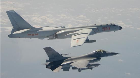 A Taiwanese F-16 fighter jet flying next to a Chinese H-6 bomber (top) off the coast of Taiwan. The United States will defend Taiwan if it is attacked by China, President Joe Biden said, seemingly changing long-standing American “strategic ambiguity” on the issue. (AFP) A Taiwanese F-16 fighter jet flying next to a Chinese H-6 bomber (top) off the coast of Taiwan. The United States will defend Taiwan if it is attacked by China, President Joe Biden said, seemingly changing long-standing American “strategic ambiguity” on the issue. (AFP)