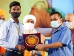 Delhi chief minister Arvind Kejriwal felicitates a student during Valmiki Jayanti celebration, at Thyagraj stadium, in New Delhi, on Saturday. (HT) Delhi chief minister Arvind Kejriwal felicitates a student during Valmiki Jayanti celebration, at Thyagraj stadium, in New Delhi, on Saturday. (HT)