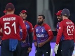 England's Adil Rashid, centre is congratulated by teammates after taking the wicket of West Indies' Andre Russell during the Cricket T20 World Cup match between England and the West Indies at the Dubai International Cricket Stadium, in Dubai, UAE, Saturday, Oct. 23, 2021. (AP Photo/Aijaz Rahi)