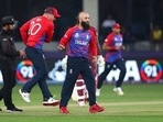 England's Moeen Ali, right, celebrates after taking the wicket of West Indies' Lendl Simmons caught by England's Liam Livingstone during the Cricket T20 World Cup match between England and the West Indies at the Dubai International Cricket Stadium, in Dubai, UAE, Saturday, Oct. 23, 2021.(AP) England's Moeen Ali, right, celebrates after taking the wicket of West Indies' Lendl Simmons caught by England's Liam Livingstone during the Cricket T20 World Cup match between England and the West Indies at the Dubai International Cricket Stadium, in Dubai, UAE, Saturday, Oct. 23, 2021.(AP)