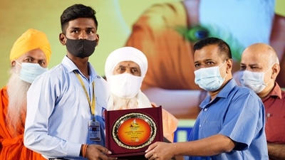 Delhi chief minister Arvind Kejriwal felicitates a student during Valmiki Jayanti celebration, at Thyagraj stadium, in New Delhi, on Saturday. (HT) Delhi chief minister Arvind Kejriwal felicitates a student during Valmiki Jayanti celebration, at Thyagraj stadium, in New Delhi, on Saturday. (HT)