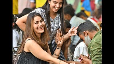 Women get henna on their hands a day before Karva Chauth in Ludhiana on Saturday. (Gurpreet Singh/HT)