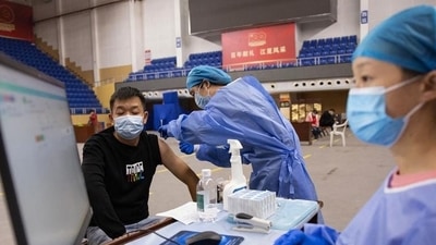 A resident receives the Sinopharm Covid-19 vaccine in Wuhan in China's central Hubei province on October 14, 2021. (AFP) A resident receives the Sinopharm Covid-19 vaccine in Wuhan in China's central Hubei province on October 14, 2021. (AFP)