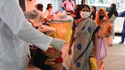 A health worker takes a swab sample from a youth to test for the Covid-19 coronavirus at a testing center in New Delhi. ( AFP) A health worker takes a swab sample from a youth to test for the Covid-19 coronavirus at a testing center in New Delhi. ( AFP)