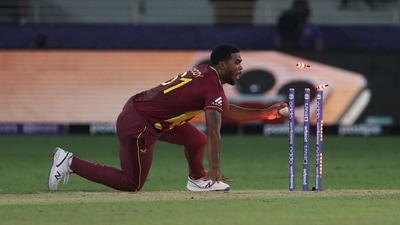 Dubai: West Indies' Obed McCoy takes the ball and hits the wicket to run out England's Moeen Ali during the Cricket T20 World Cup match between England and the West Indies at the Dubai International Cricket Stadium, in Dubai, UAE, Saturday, Oct. 23, 2021. AP/PTI(AP10_23_2021_000208A) (AP) Dubai: West Indies' Obed McCoy takes the ball and hits the wicket to run out England's Moeen Ali during the Cricket T20 World Cup match between England and the West Indies at the Dubai International Cricket Stadium, in Dubai, UAE, Saturday, Oct. 23, 2021. AP/PTI(AP10_23_2021_000208A) (AP)