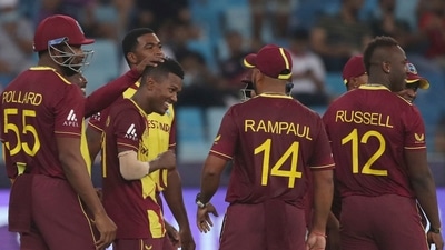 Dubai: West Indies' Akeal Hosein, 3rd left, celebrates after taking the wicket of England's Liam Livingstone caught and bowled during the Cricket T20 World Cup match between England and the West Indies at the Dubai International Cricket Stadium, in Dubai, UAE, Saturday, Oct. 23, 2021. AP/PTI(AP10_23_2021_000213B) (AP) Dubai: West Indies' Akeal Hosein, 3rd left, celebrates after taking the wicket of England's Liam Livingstone caught and bowled during the Cricket T20 World Cup match between England and the West Indies at the Dubai International Cricket Stadium, in Dubai, UAE, Saturday, Oct. 23, 2021. AP/PTI(AP10_23_2021_000213B) (AP)