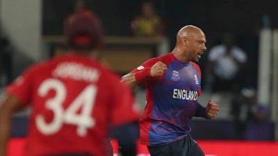 England's Tymal Mills celebrates after taking the wicket of West Indies' Nicholas Pooran caught out by England's Jos Buttler during the Cricket T20 World Cup match between England and the West Indies at the Dubai International Cricket Stadium, in Dubai, UAE, Saturday, Oct. 23, 2021. (AP Photo/Aijaz Rahi) (AP) England's Tymal Mills celebrates after taking the wicket of West Indies' Nicholas Pooran caught out by England's Jos Buttler during the Cricket T20 World Cup match between England and the West Indies at the Dubai International Cricket Stadium, in Dubai, UAE, Saturday, Oct. 23, 2021. (AP Photo/Aijaz Rahi) (AP)