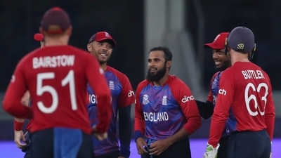England's Adil Rashid, centre is congratulated by teammates after taking the wicket of West Indies' Andre Russell during the Cricket T20 World Cup match between England and the West Indies at the Dubai International Cricket Stadium, in Dubai, UAE, Saturday, Oct. 23, 2021. (AP Photo/Aijaz Rahi) (AP) England's Adil Rashid, centre is congratulated by teammates after taking the wicket of West Indies' Andre Russell during the Cricket T20 World Cup match between England and the West Indies at the Dubai International Cricket Stadium, in Dubai, UAE, Saturday, Oct. 23, 2021. (AP Photo/Aijaz Rahi) (AP)
