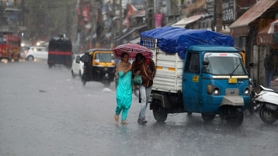 People walk in the rain in Jammu on Saturday, October 23. The Jammu-Srinagar highway, that connects Kashmir valley to the rest of India, remained closed for traffic as higher reaches of Kashmir received fresh snowfall while heavy rains lashed the plains. (AP) People walk in the rain in Jammu on Saturday, October 23. The Jammu-Srinagar highway, that connects Kashmir valley to the rest of India, remained closed for traffic as higher reaches of Kashmir received fresh snowfall while heavy rains lashed the plains. (AP)
