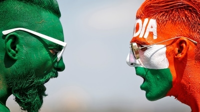 Cricket fans, with their faces painted in the Indian and Pakistani national flag colours, pose for a picture ahead of the first match between India and Pakistan in Twenty20 World Cup super 12 stage in Dubai (REUTERS)