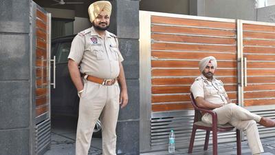 Police personnel deployed outside a house in Model Town area during income tax raids in Ludhiana on Thursday. (HT FILE)