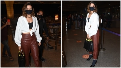 Deepika chose a cropped white shirt with a front knot, a black bralette with a scooped neckline and high waist leather pants featuring folded cuffs to catch a flight out of the bay. She accessorised her ensemble with a chunky necklace, a Gucci Diana tote bag, and a black face mask. (HT Photo/Varinder Chawla) Deepika chose a cropped white shirt with a front knot, a black bralette with a scooped neckline and high waist leather pants featuring folded cuffs to catch a flight out of the bay. She accessorised her ensemble with a chunky necklace, a Gucci Diana tote bag, and a black face mask. (HT Photo/Varinder Chawla)