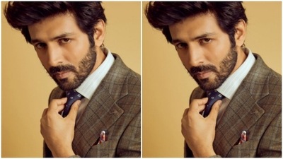 In a dark ochre checkered suit, Kartik Aaryan posed for the cameras. (Instagram/@kartikaaryan) In a dark ochre checkered suit, Kartik Aaryan posed for the cameras. (Instagram/@kartikaaryan)