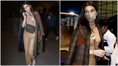 Kriti wore a tan turtleneck crop top teamed with a pair of wide-leg matching leather pants. The Mimi actor layered her ensemble with a trench coat that came in check print. A 'K' initial face mask to keep herself safe and centre-parted open locks rounded off her look. (HT Photo/Varinder Chawla) Kriti wore a tan turtleneck crop top teamed with a pair of wide-leg matching leather pants. The Mimi actor layered her ensemble with a trench coat that came in check print. A 'K' initial face mask to keep herself safe and centre-parted open locks rounded off her look. (HT Photo/Varinder Chawla)