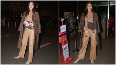 Kriti opted for a pair of nude-coloured heels, a chunky gold chain, earrings, and an over-the-body bag to accessorise the airport look. Kohl-clad eyes, glowing skin, nude lip shade, and minimal make-up rounded off her beauty picks. (HT Photo/Varinder Chawla) Kriti opted for a pair of nude-coloured heels, a chunky gold chain, earrings, and an over-the-body bag to accessorise the airport look. Kohl-clad eyes, glowing skin, nude lip shade, and minimal make-up rounded off her beauty picks. (HT Photo/Varinder Chawla)