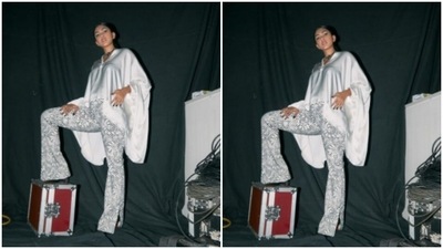 She teamed a satin white top and paired it with a pair of checkered shimmery trousers. (Instagram/@mrunalthakur) She teamed a satin white top and paired it with a pair of checkered shimmery trousers. (Instagram/@mrunalthakur)